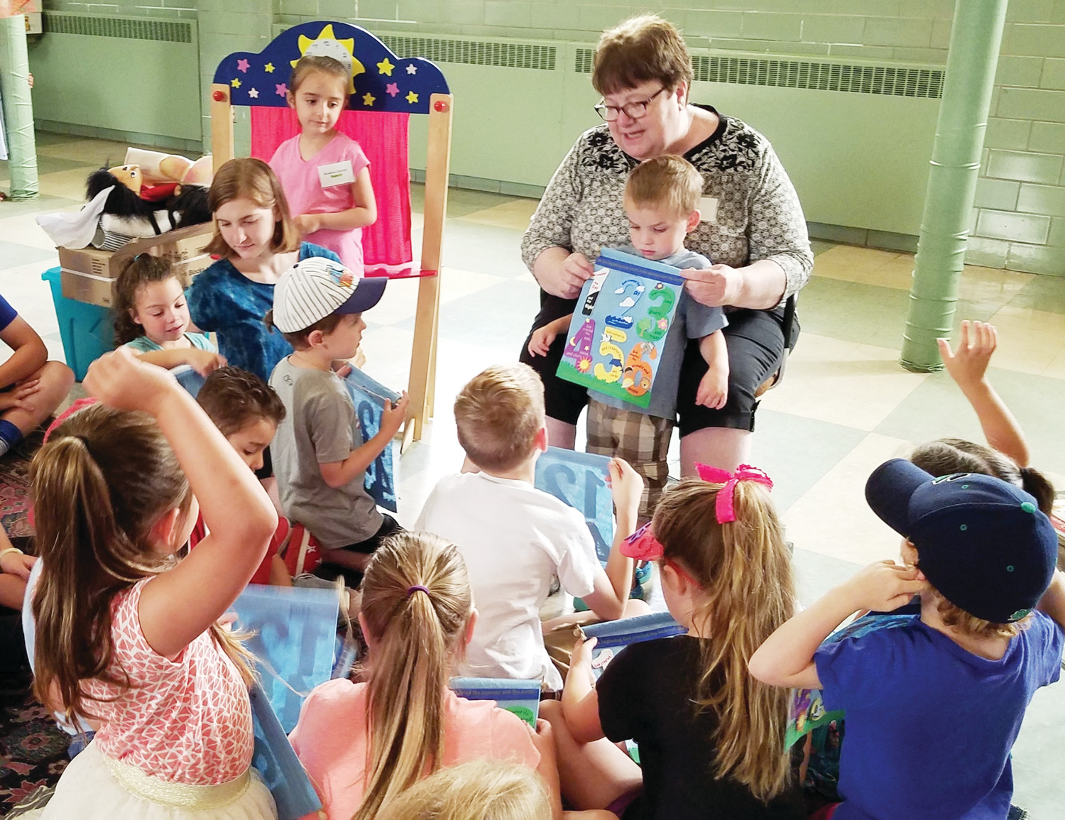 Christine Magowan, director of Faith Formation and Evangelization at St. Pius X Parish in Westerly, planned a successful five-day morning Vacation Bible School program for about 25 of the parish’s children. Above Magowan talks to the children about the creation story.